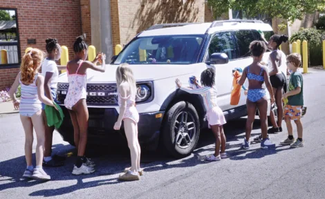 Summer campers run car wash